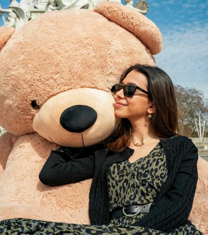 lady in sunglasses with giant brown teddy bear