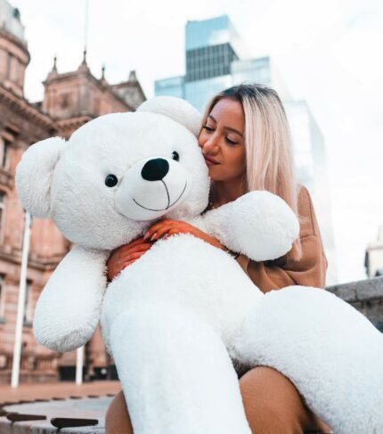 beautiful blonde lady hold white teddy bear