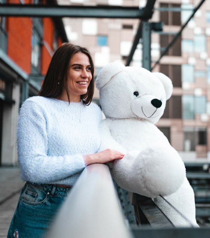 beautiful lady posing with white teddy bear