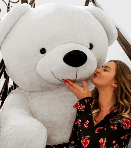 beautiful lady kissing white teddy bear