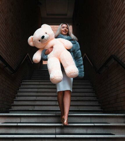 beautiful blonde lady cuddling teddy bear