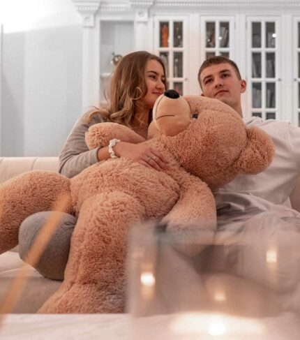 cute couple romantic cuddling teddy bear at home