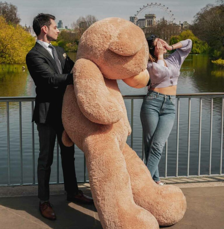 boyfriend surprising girlfriend with huge teddy bear