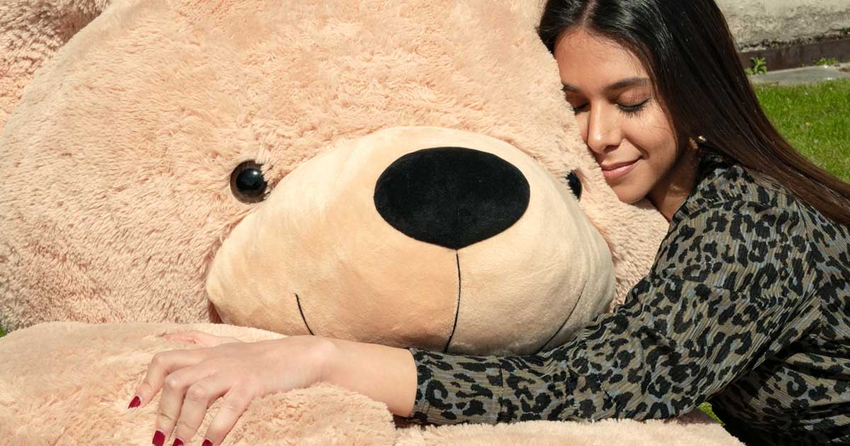 lady hugging giant light brown teddy bear