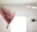 pink heart shaped balloon floating in room