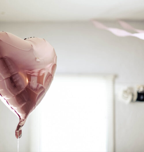 pink heart shaped balloon floating in room